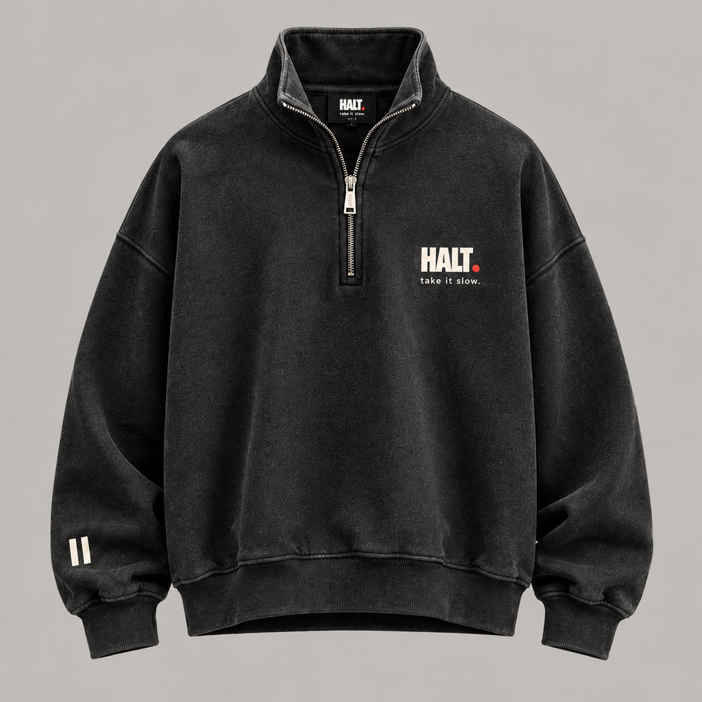 Front of HALT. washed black oversized quarter zip sweatshirt with HALT. take it slow chest print and funnel neck collar