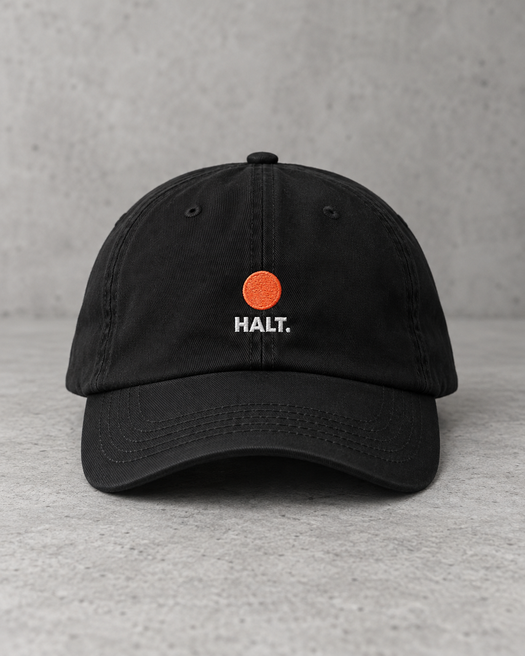 HALT. Dot Cap - black low-profile baseball cap with embroidered coral dot logo, front view