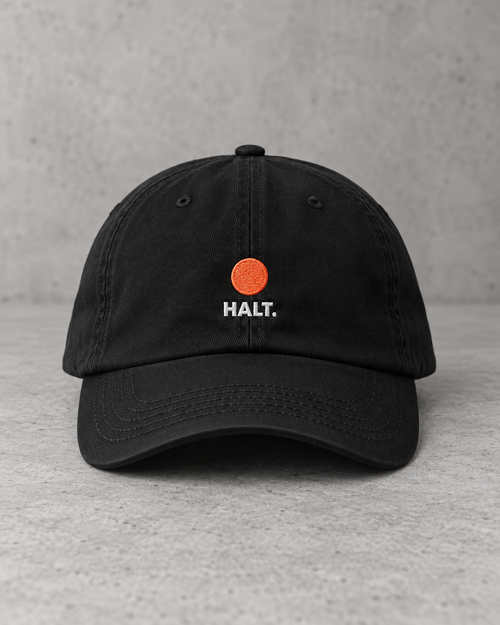 HALT. Dot Cap - black low-profile baseball cap with embroidered coral dot logo, front view