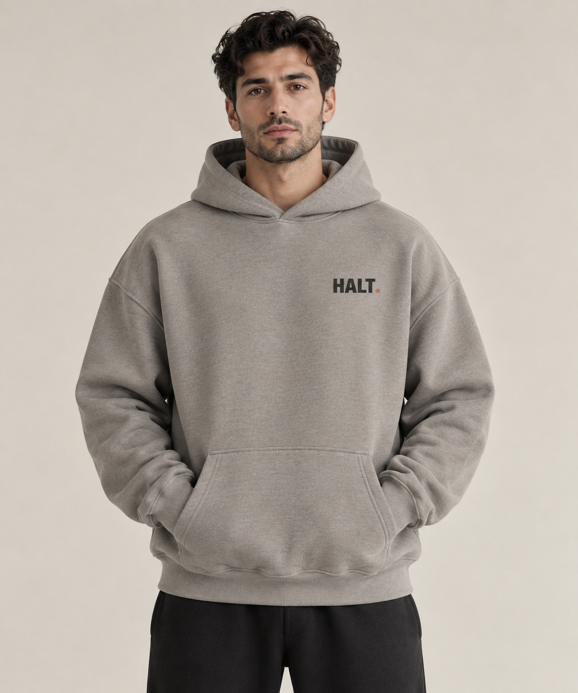 HALT. Slow Down oversized heather grey hoodie, front view with small black chest logo, unisex heavyweight streetwear pullover
