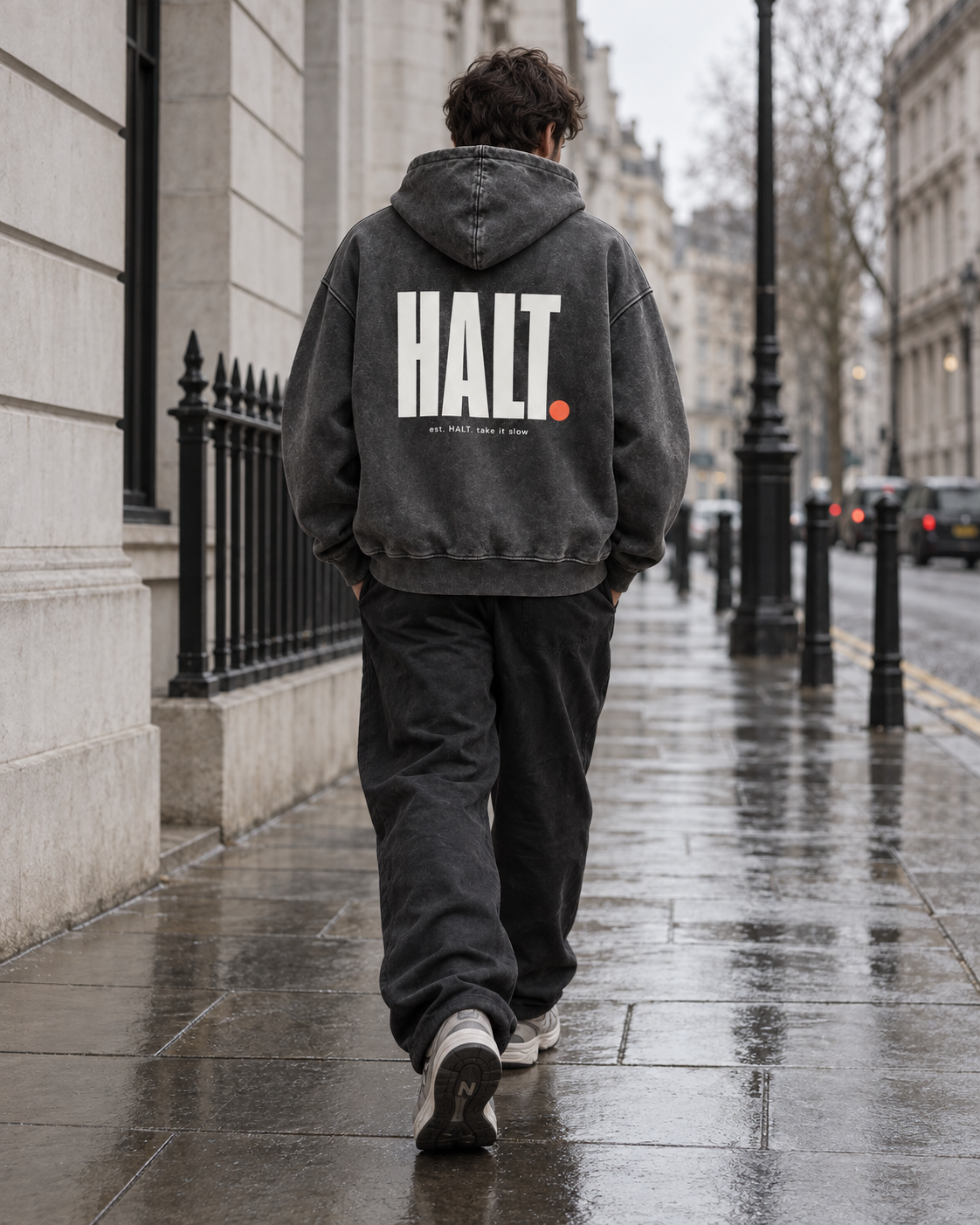 Man wearing the HALT. Signature Hoodie in washed charcoal, an oversized hoodie with double-layer hood, styled on a London street